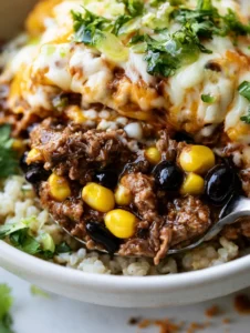 Extreme macro photography of seasoned ground beef with a glossy oily sheen and vibrant yellow corn. (Healthy Taco Bowl Recipe)