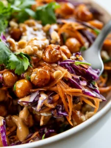 Extreme macro close-up of Thai Chickpea Salad showcasing roasted chickpeas with an oily sheen and shredded carrots.
