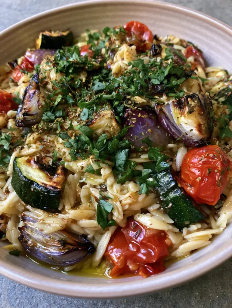 Roasted Vegetable Orzo Salad with Lemon Vinaigrette and Charred Zucchini 2 Close up shot of Roasted Vegetable Orzo Salad showing the texture of charred zucchini and ivory-colored orzo pasta pearls.