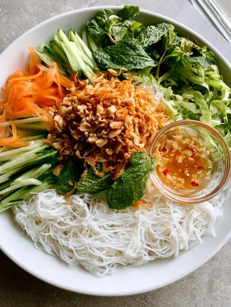 Detailed view of the garnishes on a Vietnamese Noodle Salad including crushed peanuts and fried shallots. (Vietnamese Noodle Salad)