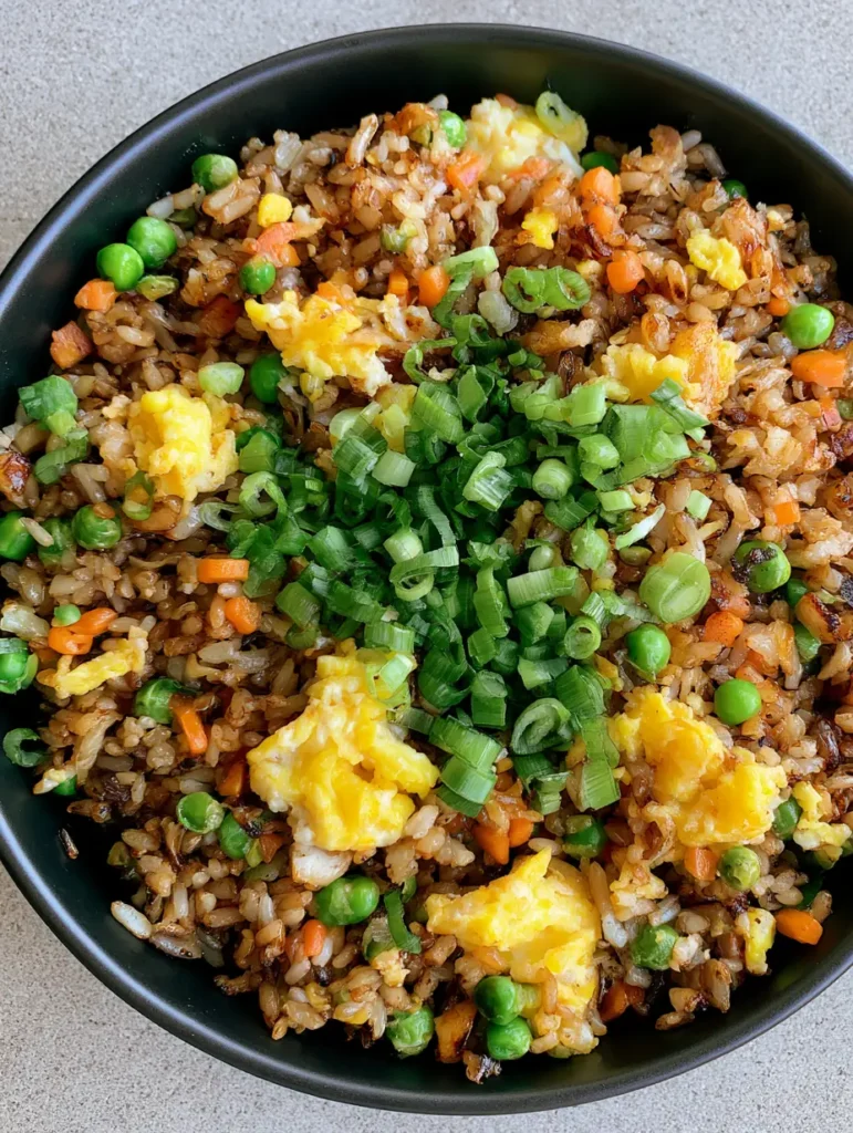 Egg Fried Rice: The Ultimate 15-Minute Better-Than-Takeout Recipe 1 Detailed view of fluffy scrambled eggs folded into Egg Fried Rice with bright green scallions.