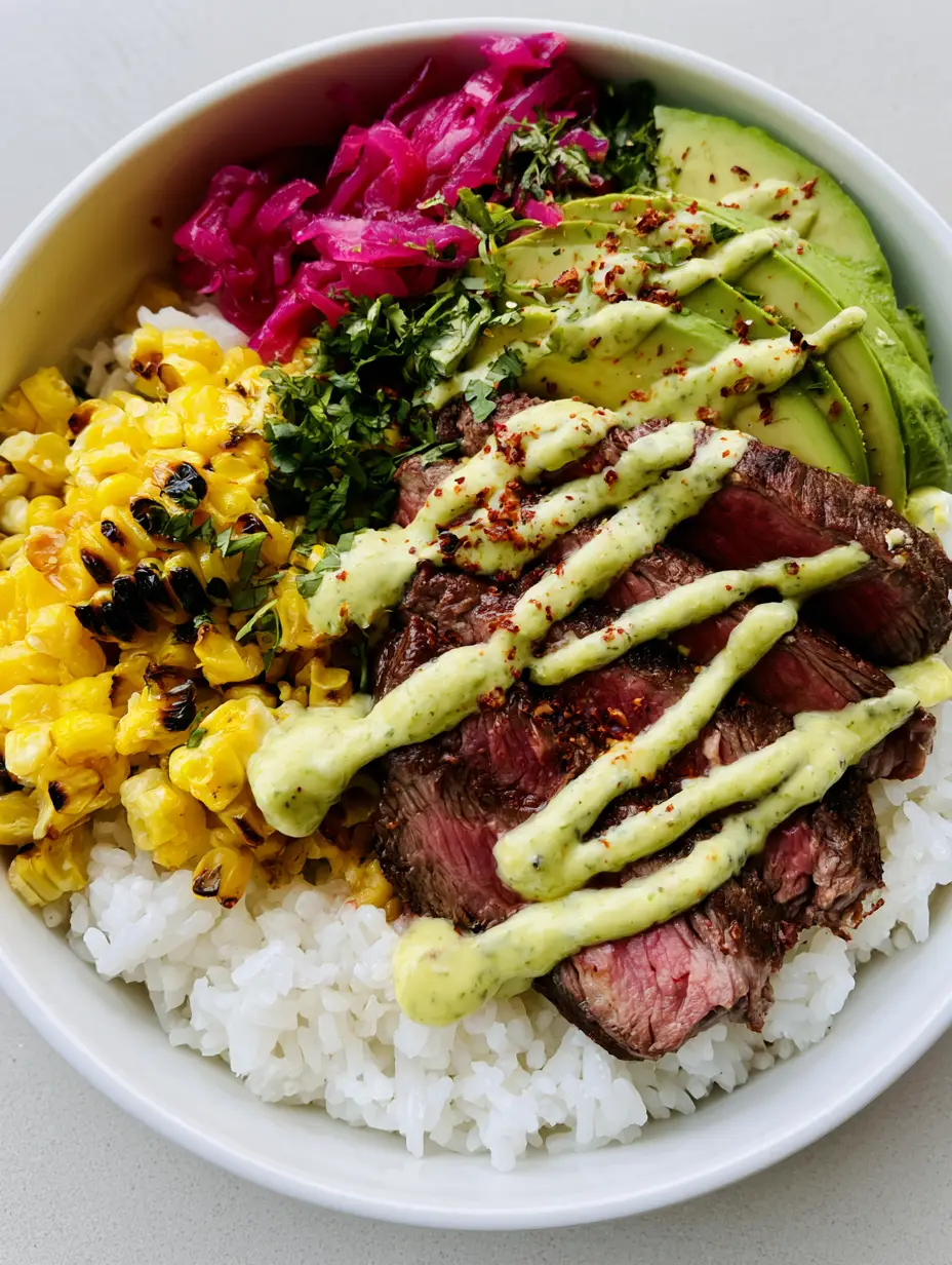 Close up of seared medium-rare sirloin steak and thick avocado slices in a rice bowl.