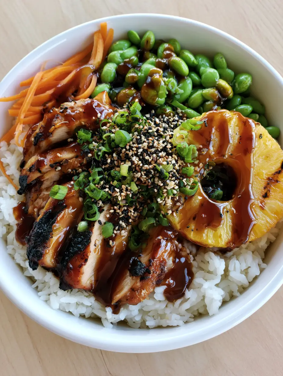 Hawaiian Chicken Bowl: The Ultimate Teriyaki Grilled Pineapple Feast 3 Overhead shot of a Hawaiian Chicken Bowl featuring glossy amber teriyaki chicken and bright green edamame.