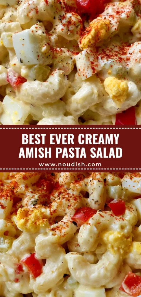 A top-down view of creamy Amish Pasta Salad in a white bowl with red peppers and paprika dusting.