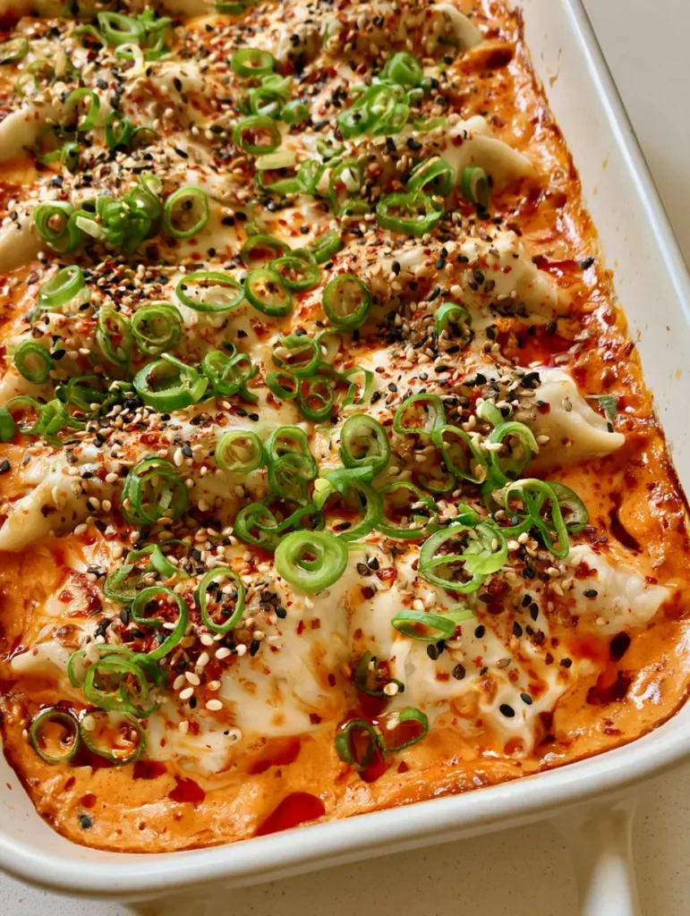 Overhead shot of Viral Dumpling Bake with golden cheese spots and sesame seeds.