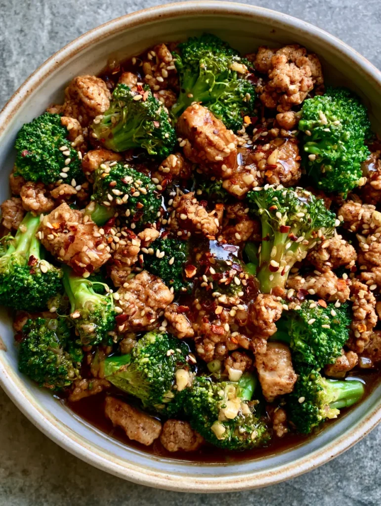 Ground Turkey Stir Fry with Garlic Broccoli and Glossy Soy Sauce 1 Detailed shot of browned ground turkey crumbles and crisp-tender broccoli florets in a savory stir fry.